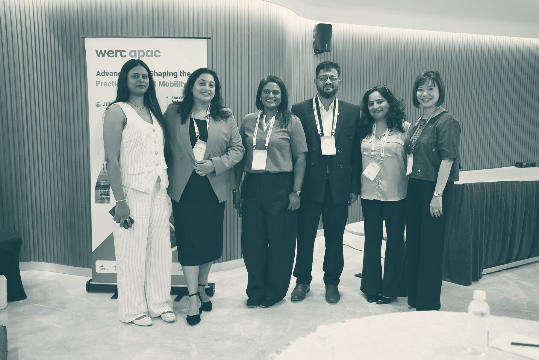 Six mobility leaders standing together in front of the WERC APAC banner in Hyderabad