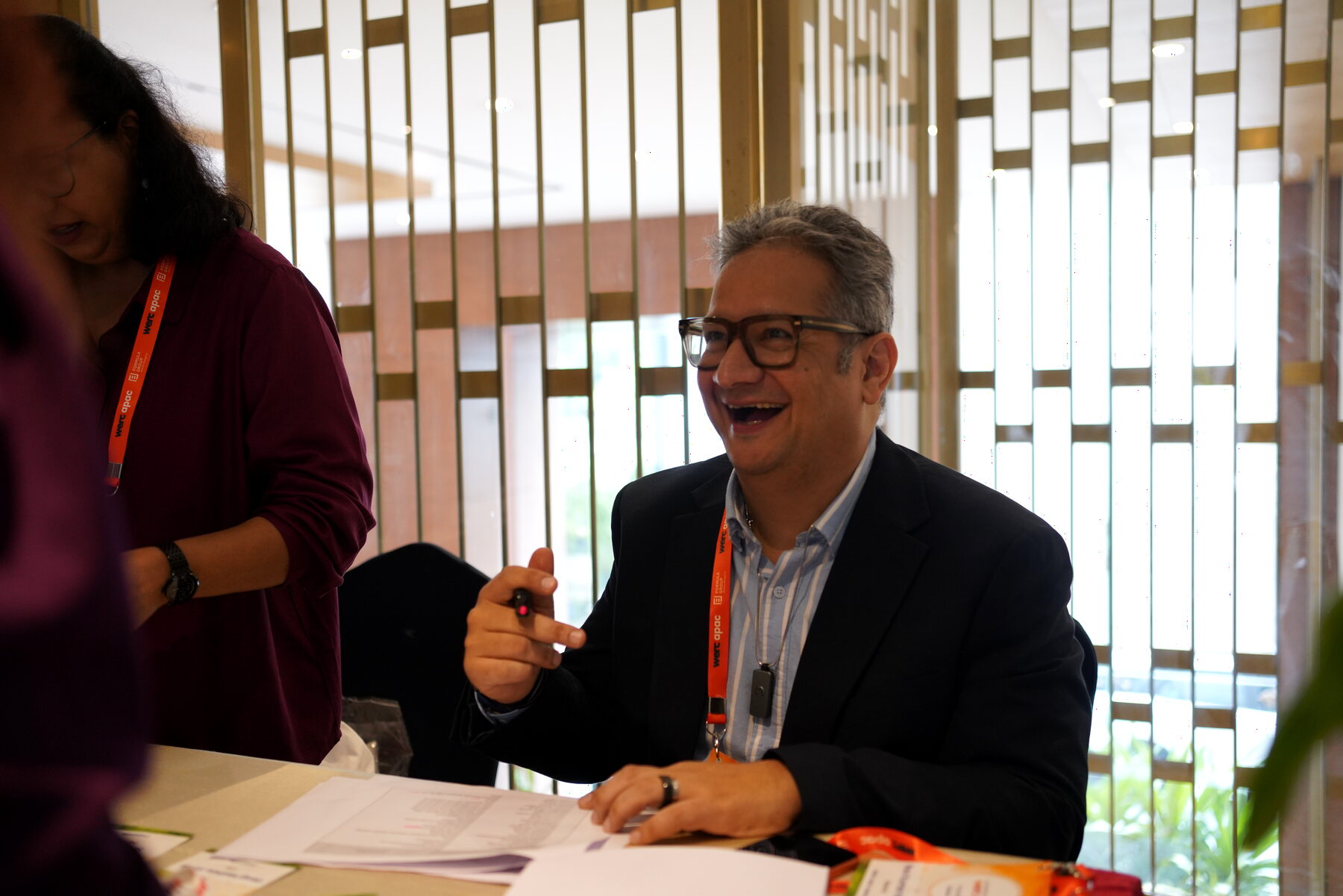 A delegate laughing at the registration desk